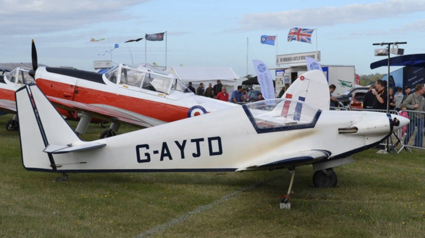 G-AYJD at an airshow, RAF Bulldogs and other aircraft in the background