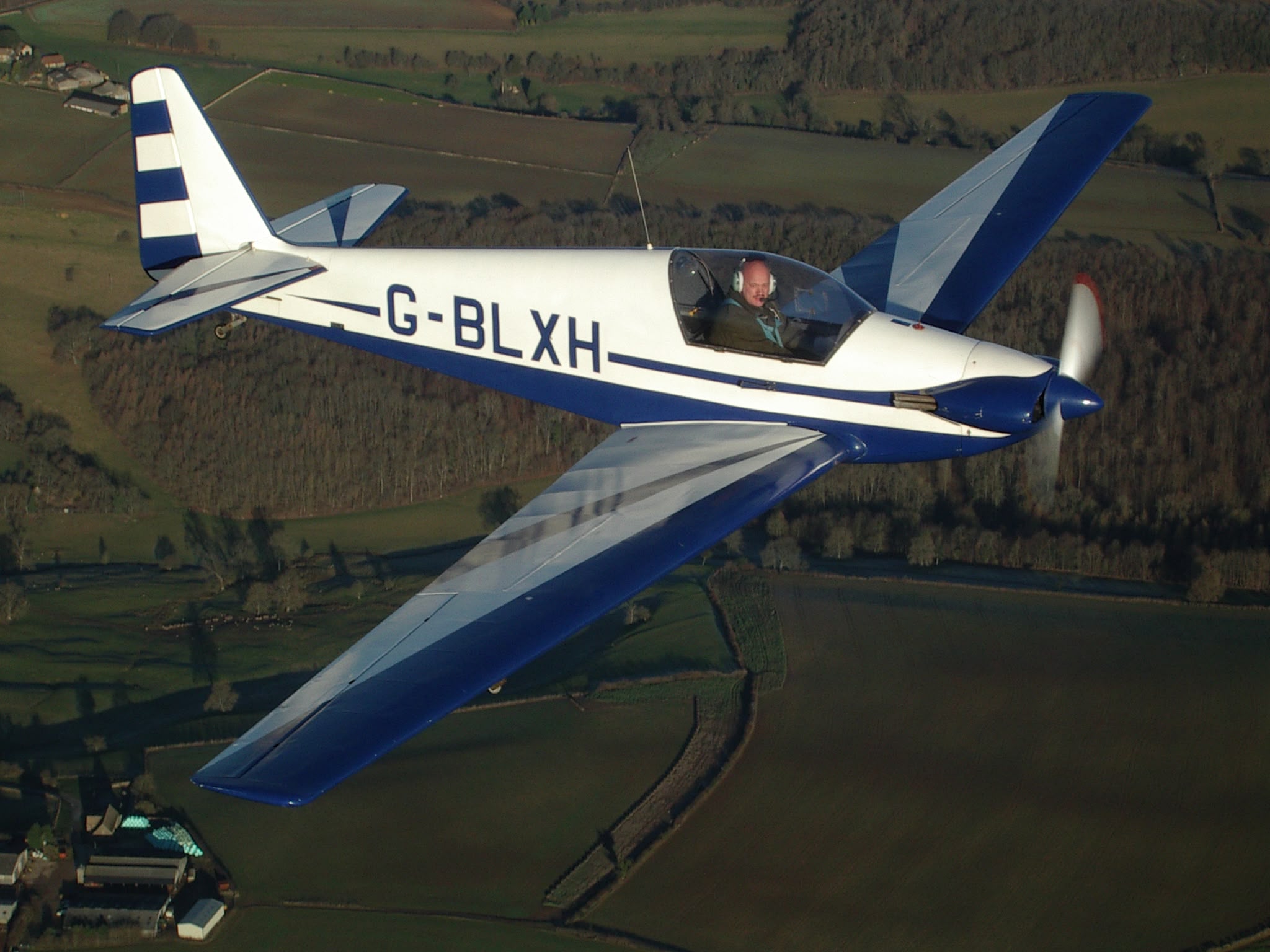 G-BLXH in flight over countryside