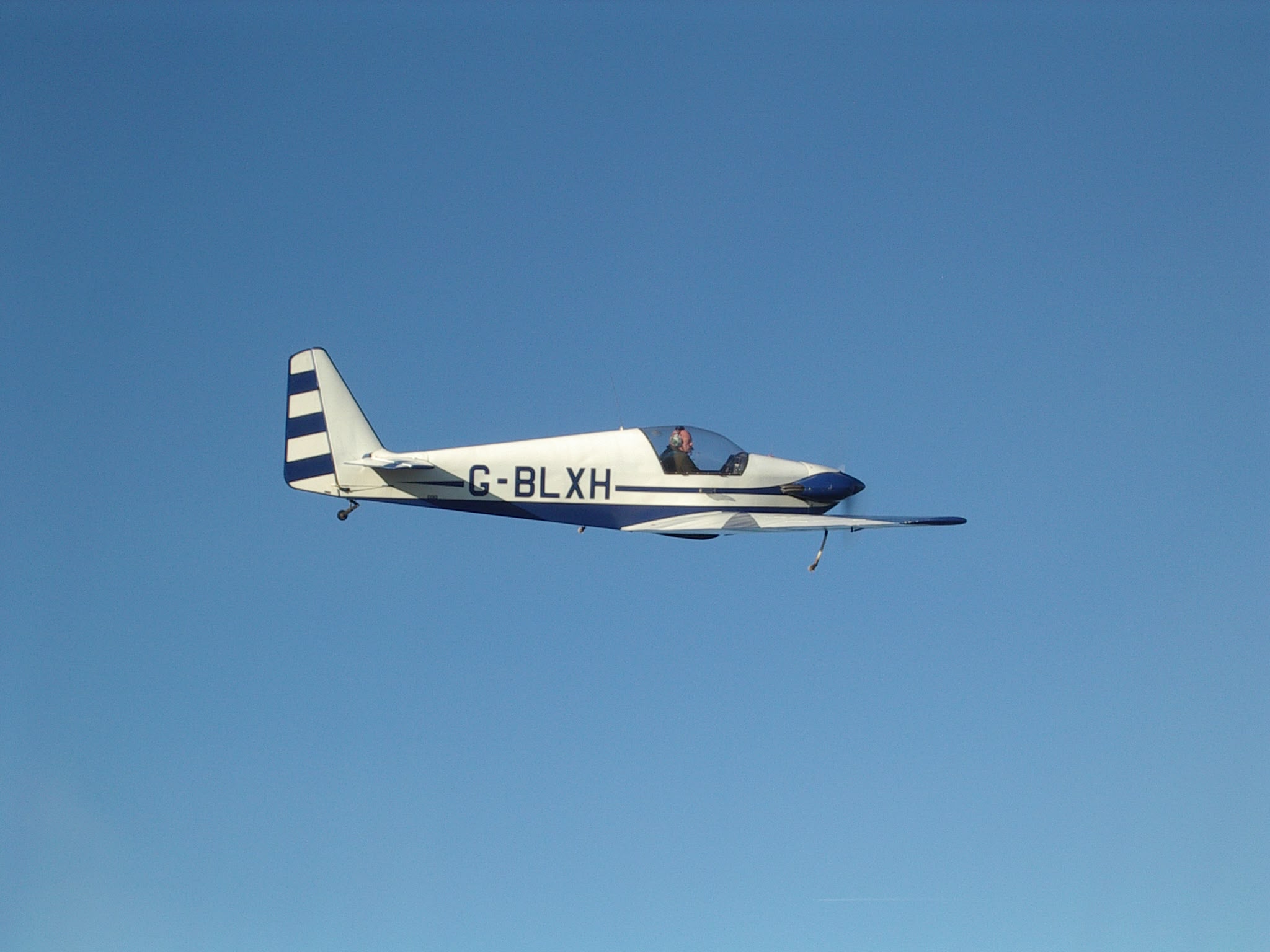 G-BLXH in flight against blue sky