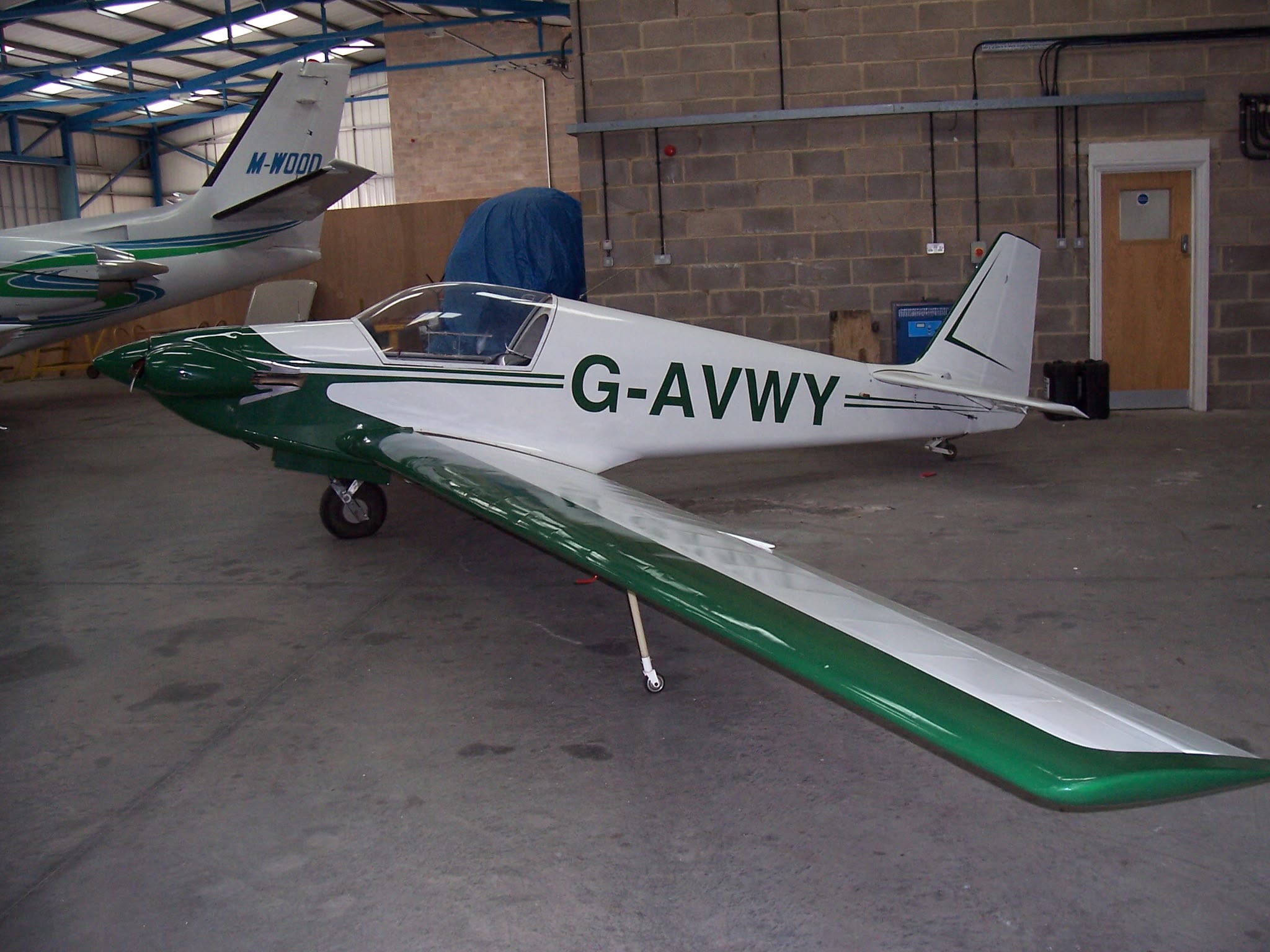 G-AVWY in green and white, in the hangar