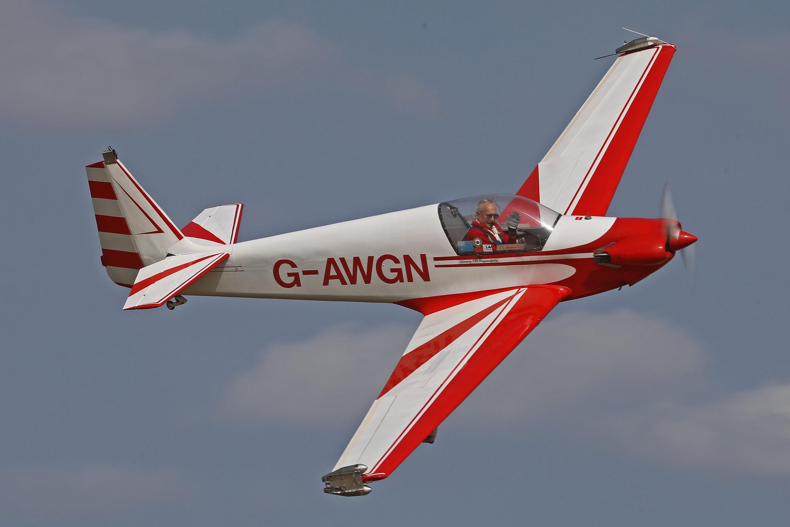 G-AWGN banking in flight, red and white
