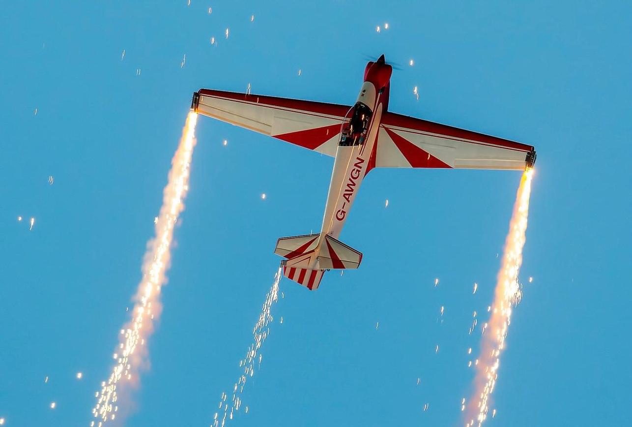 G-AWGN flying with fireworks streaming from the wingtips