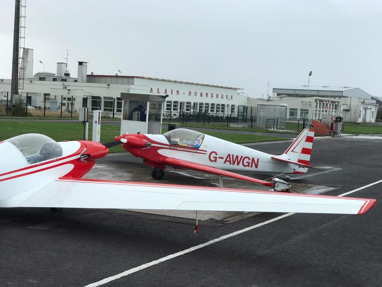 G-AWGN parked on an airfield apron beside another aircraft