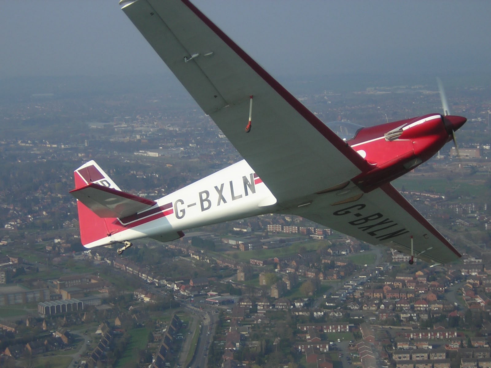G-BXLN banking, underside view over a town