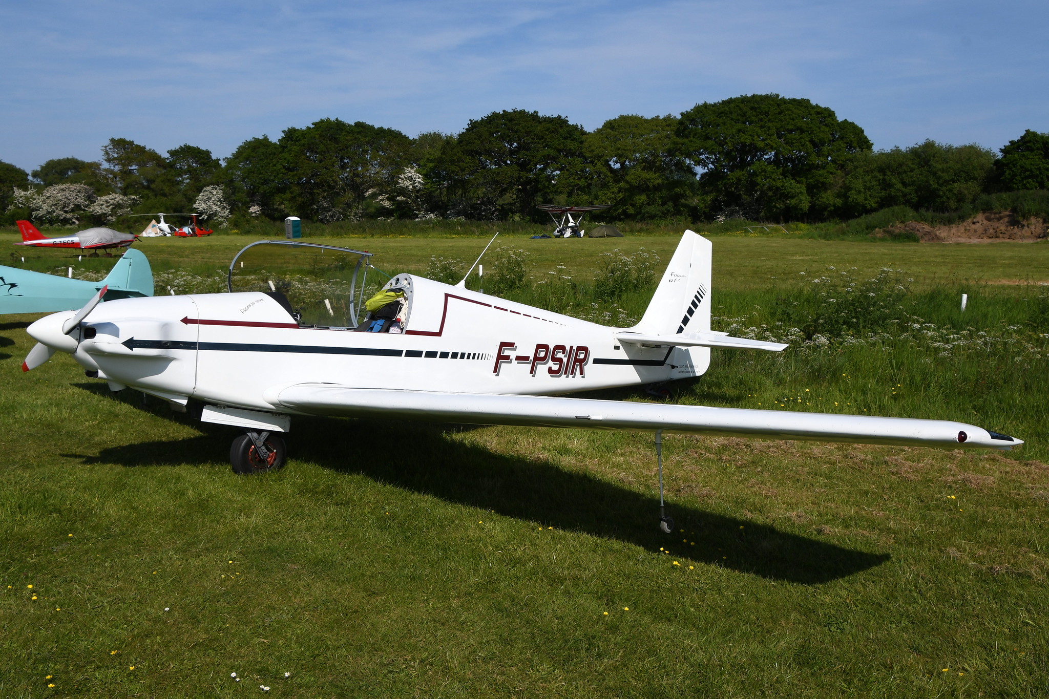 Fournier RF7 F-PSIR parked on the grass, other aircraft behind