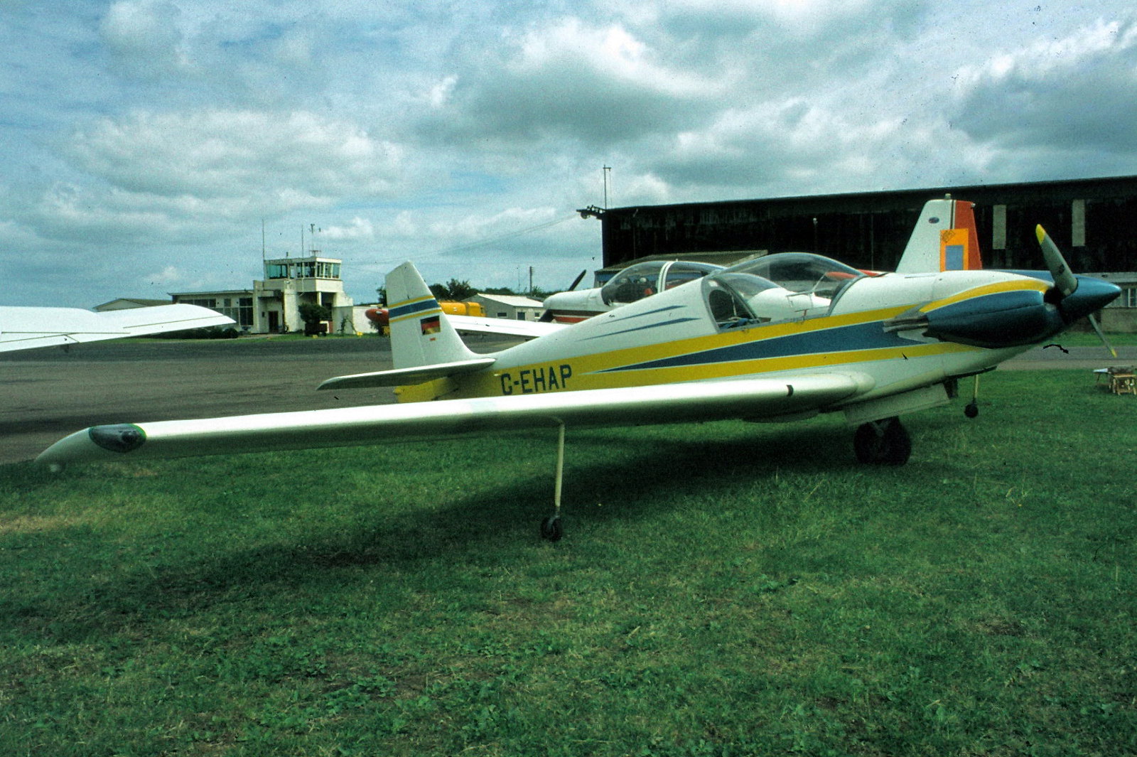 Fournier RF7 G-EHAP on the grass, blue/yellow scheme