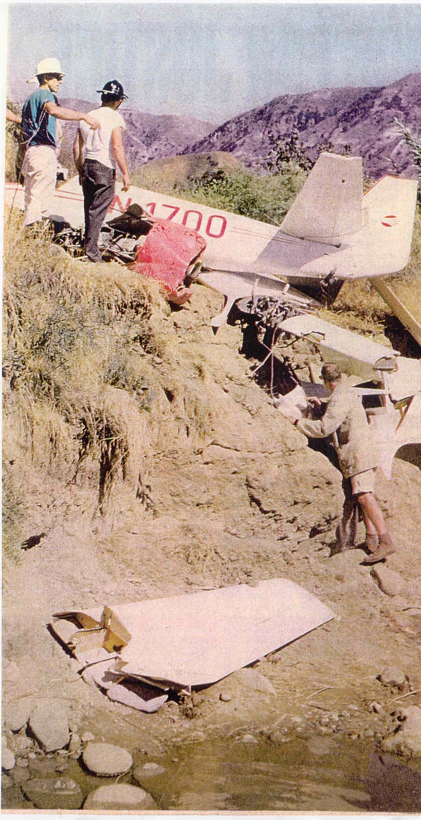 Wreckage of N1700 on a hillside near Santa Paula, with two men standing beside it