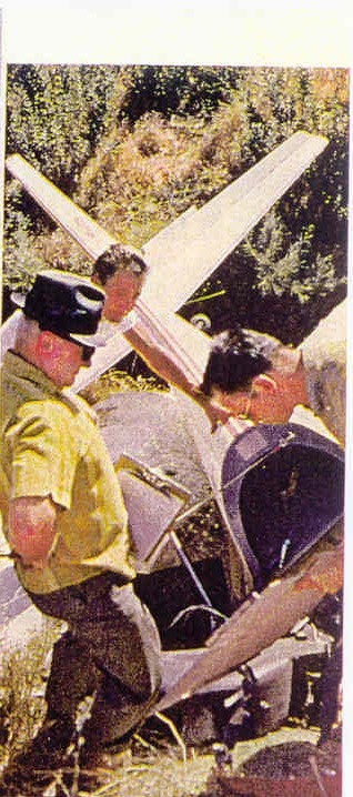 Two men working at the wreckage of N1700