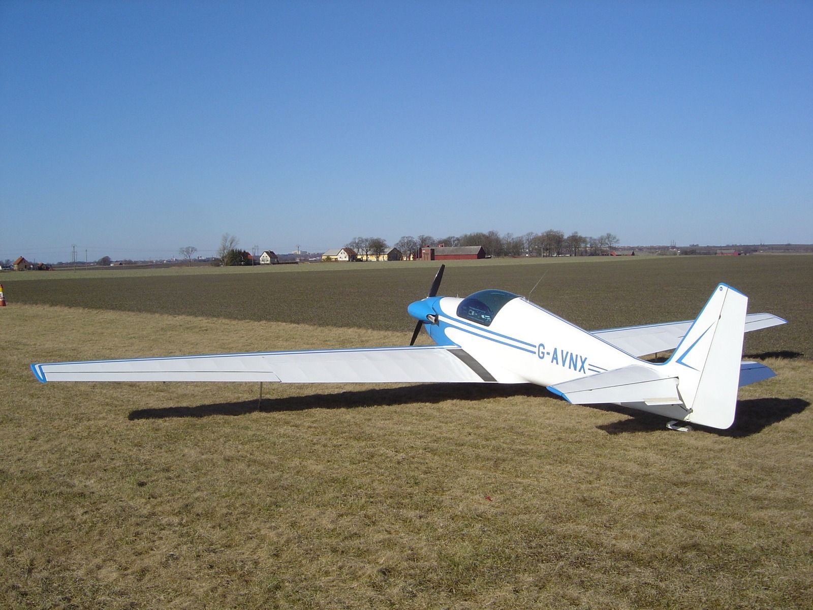 Fournier RF4 G-AVNX parked on grass at its new home airstrip in Sweden