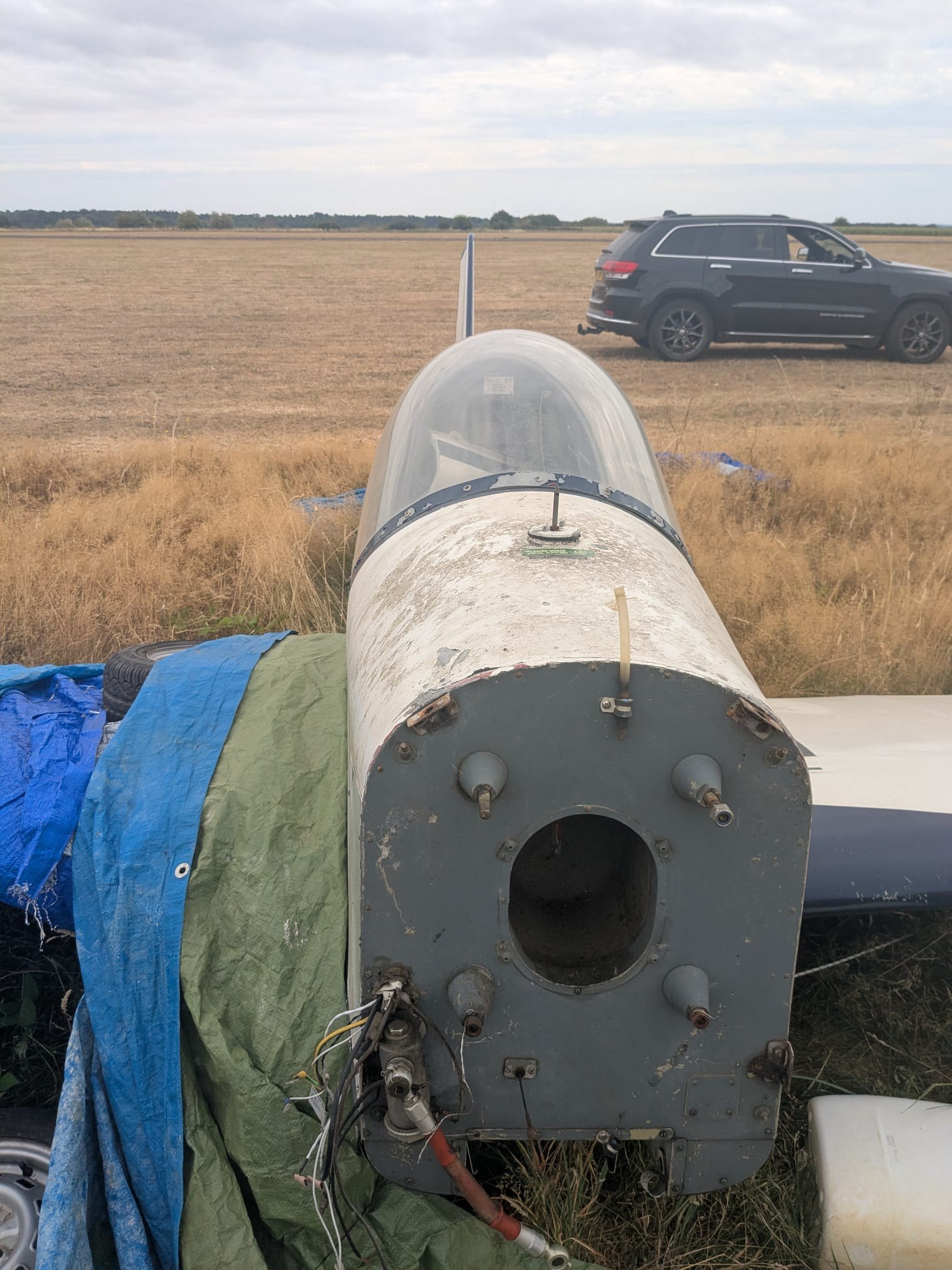 Close view of G-AYJD's firewall with the engine removed, mounting holes and wiring exposed