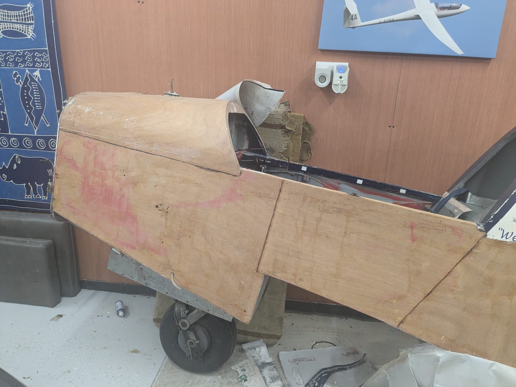 Close view of G-AYJD’s rebuilt cockpit rim and instrument coaming in bare plywood