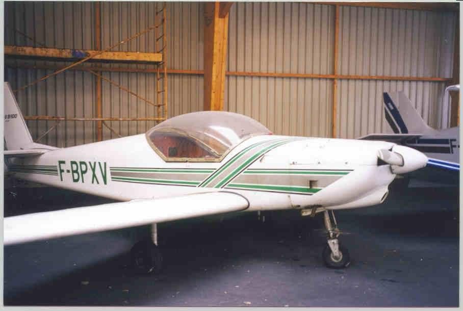 F-BPXV, white with green stripes, in a hangar