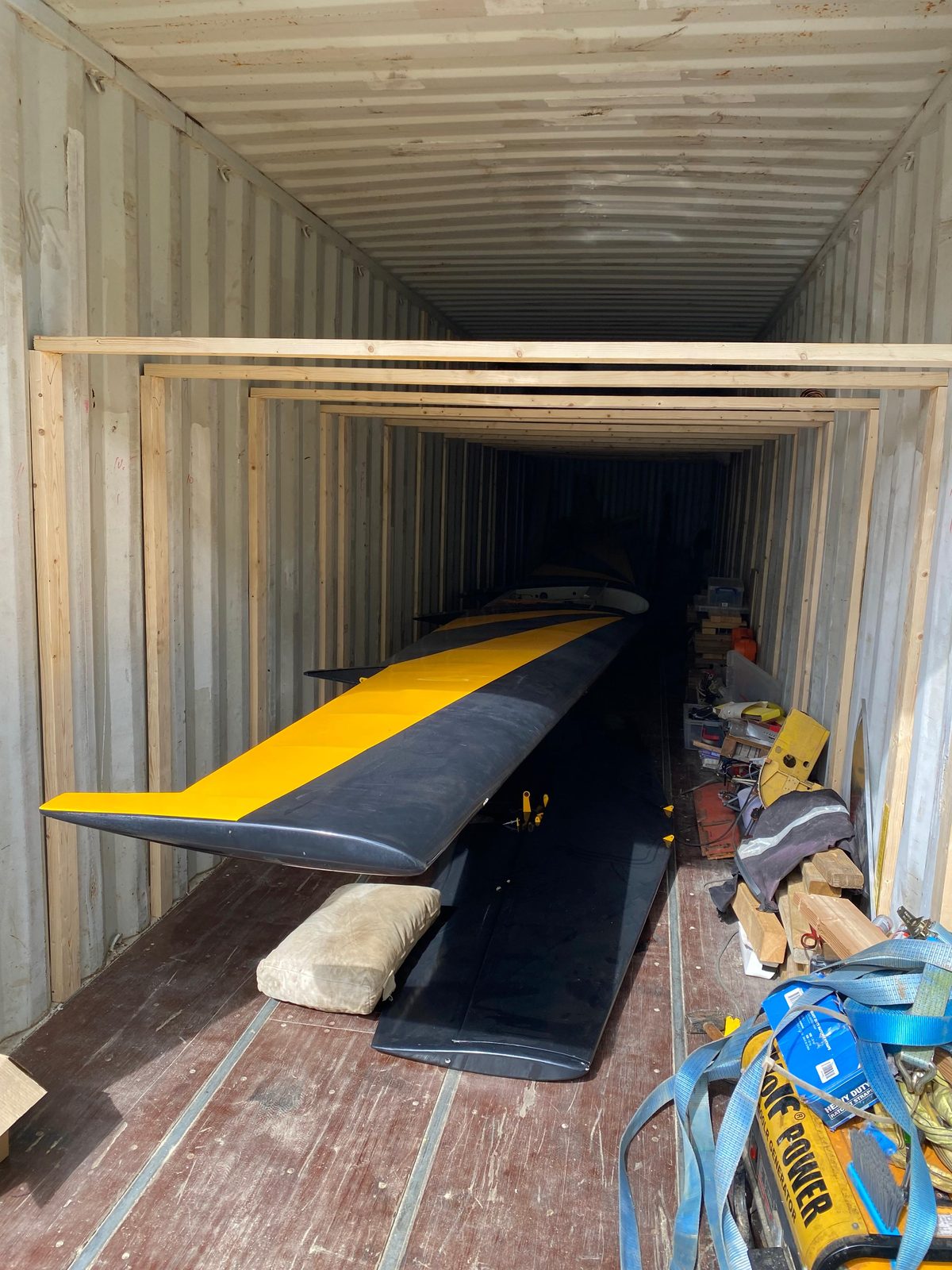 Wing stored on a stand inside the container, straps and tools alongside