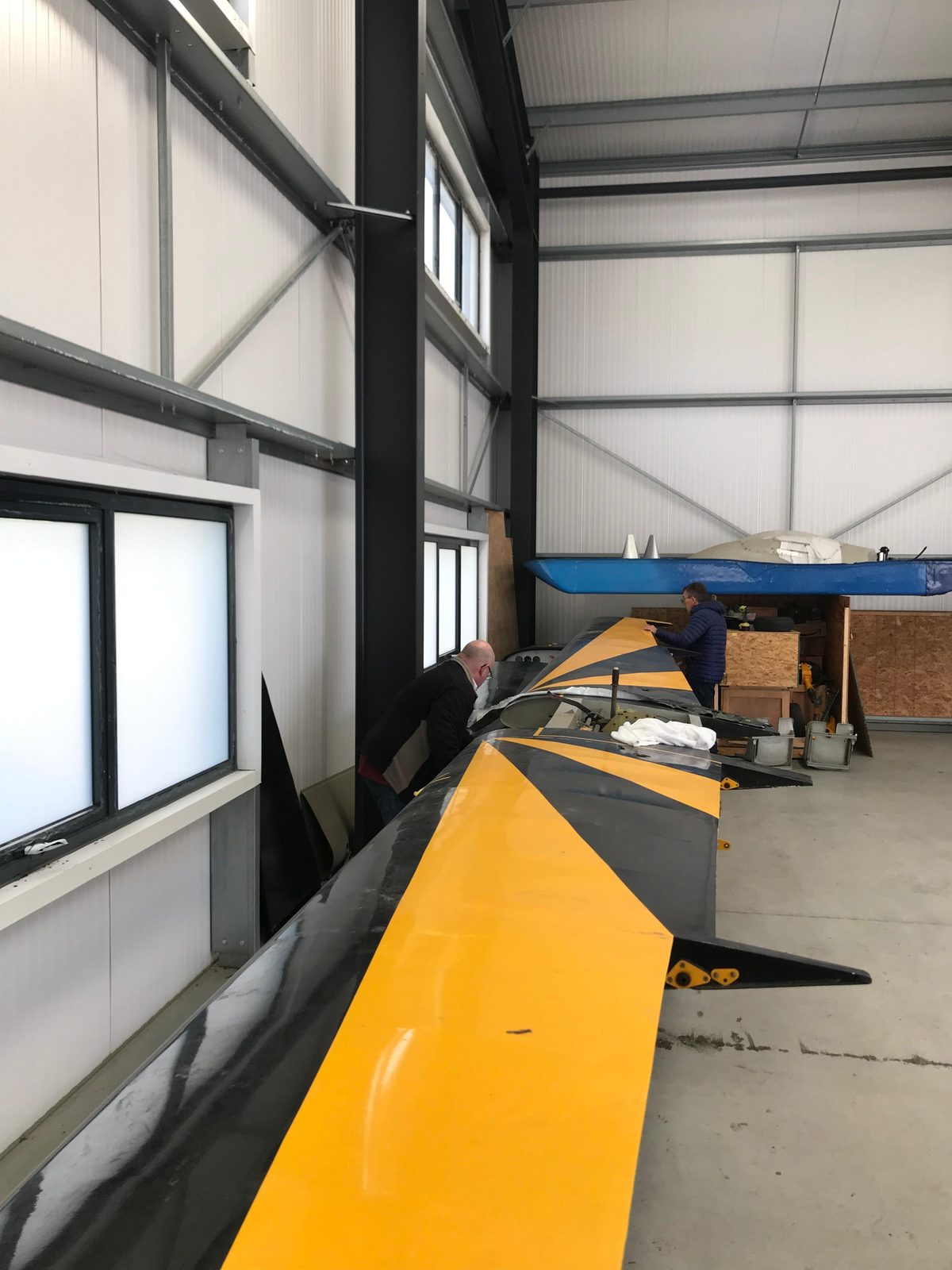 Black and yellow wing lying in the hangar