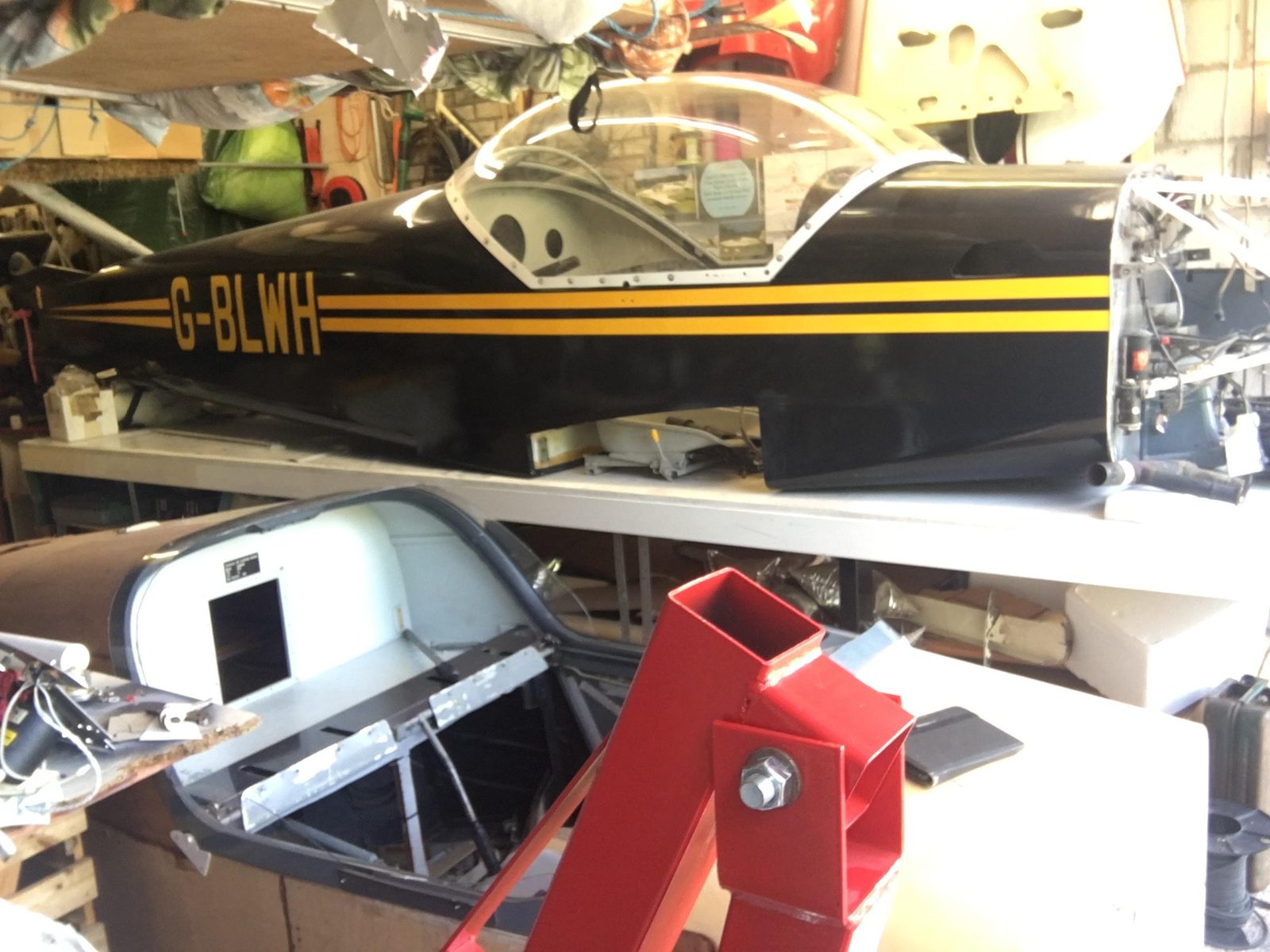 G-BLWH fuselage, black with yellow stripes, canopy fitted, in the workshop